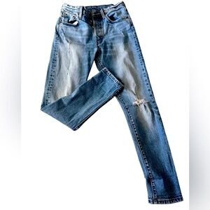 Levi’s medium wash jeans. Slightly distressed.